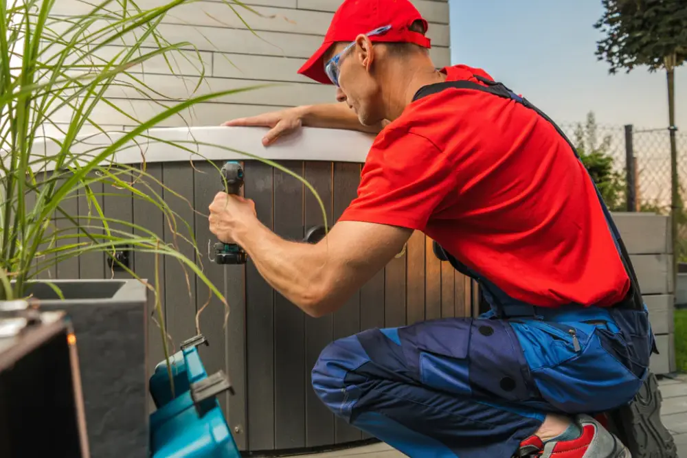 Hot tub technician repairing unit
