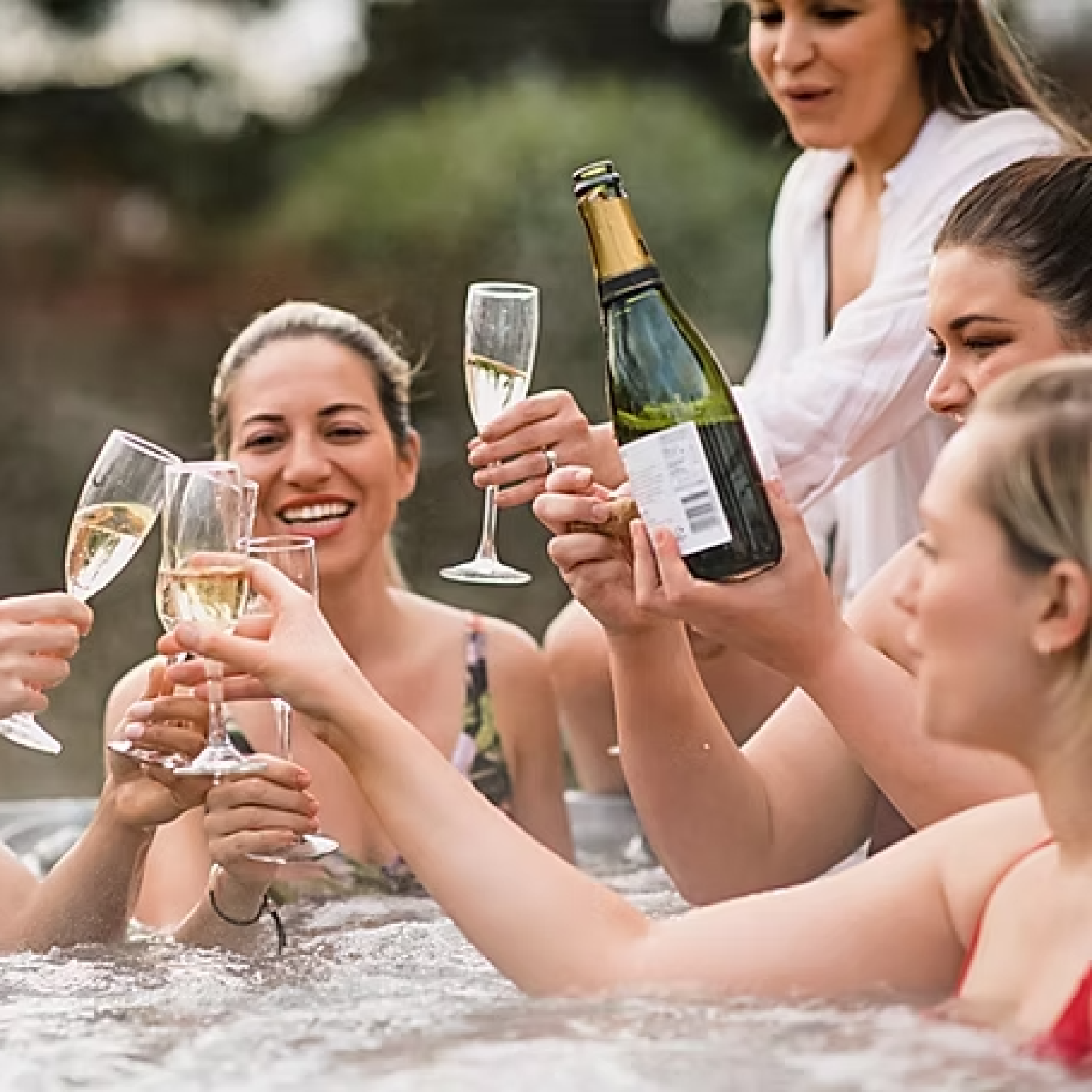 Group celebrating in hot tub spa